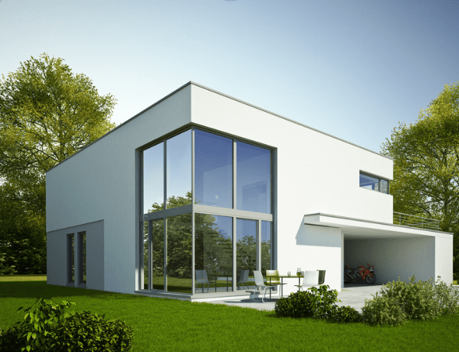 A white building with big window glasses and doors, table outside and garage